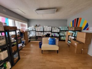 Image description: A photo of the inside of the All-Options Pregnancy Resource Center, with shelves of diapers and other supplies on 3 walls.